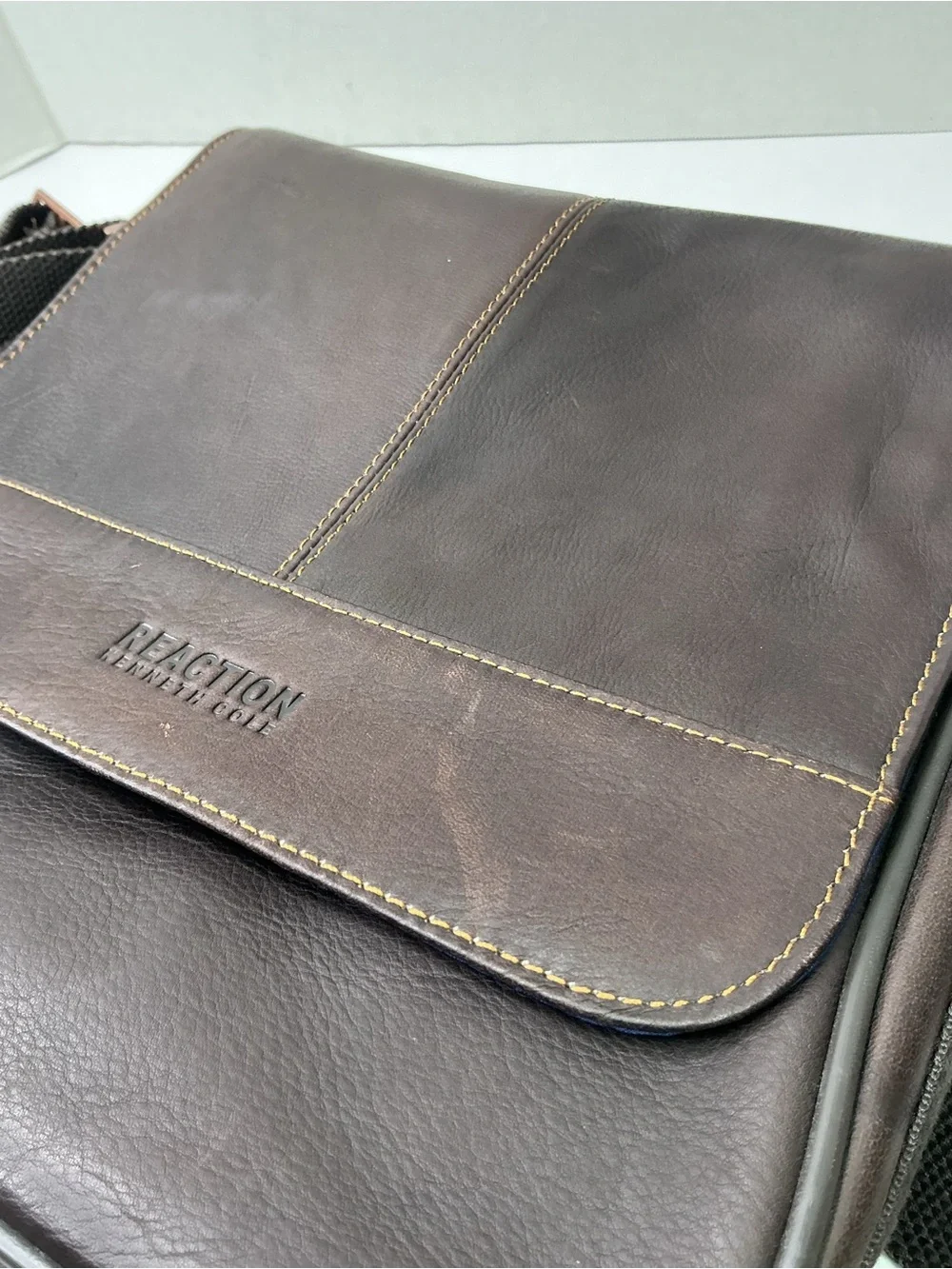 Kenneth Cole Reaction dark brown leather messenger-style tablet bag.